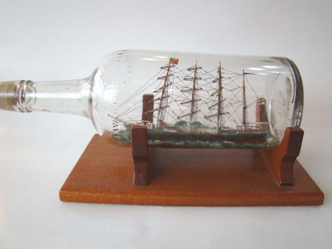 A highly detailed four masted ship in a bottle circa 1930